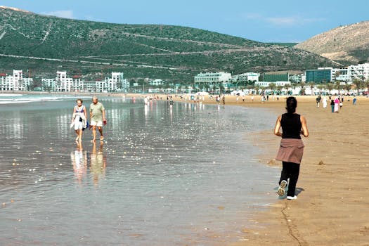 People enjoying a sunny day at a beautiful beach in Agadir, Morocco.