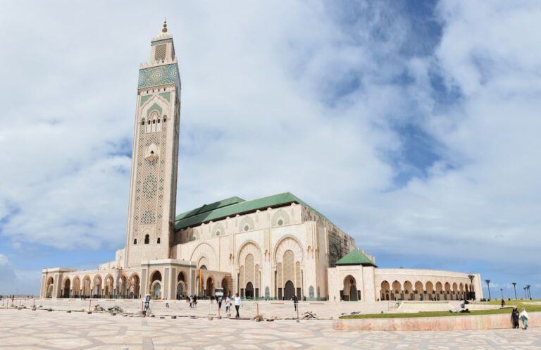 The iconic Hassan II Mosque in Casablanca under a blue sky, a key architectural masterpiece.